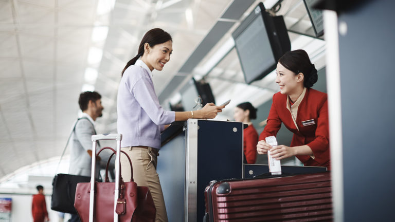 Passenger at Cathay Pacific check-in after buying Cathay miles