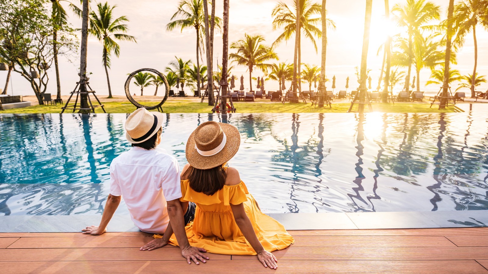 Couple sitting by resort pool