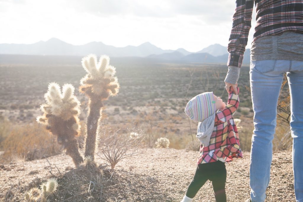baby and cactus mountain backdrop