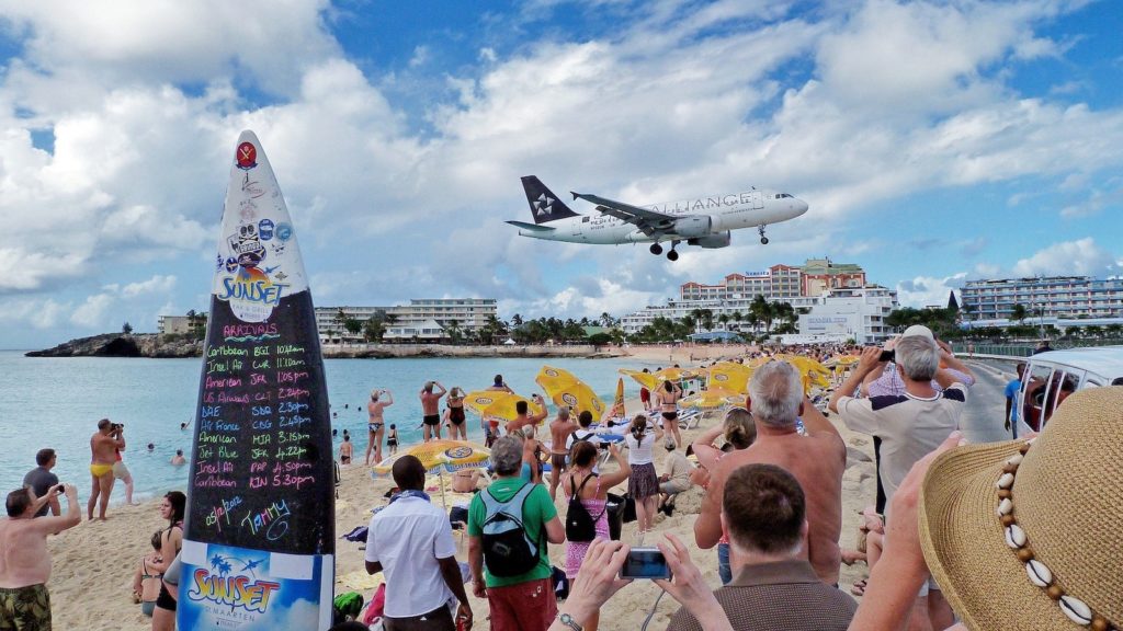 Plane landing above beach