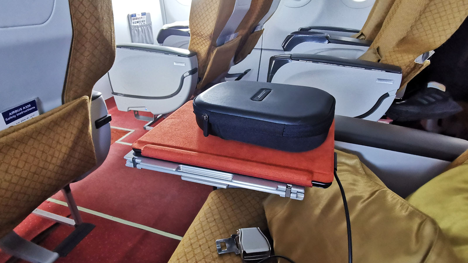 Using the tray table for extra storage in Air India A320neo Business Class