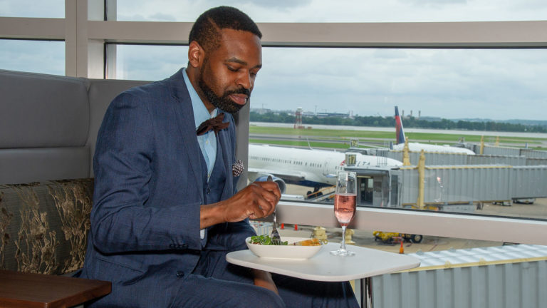 Gentleman sits in Delta Sky Club airport lounge