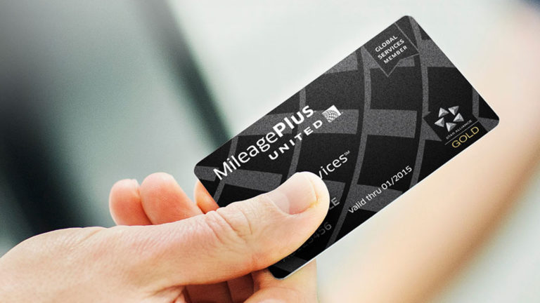 Traveller holding United Global Services membership card