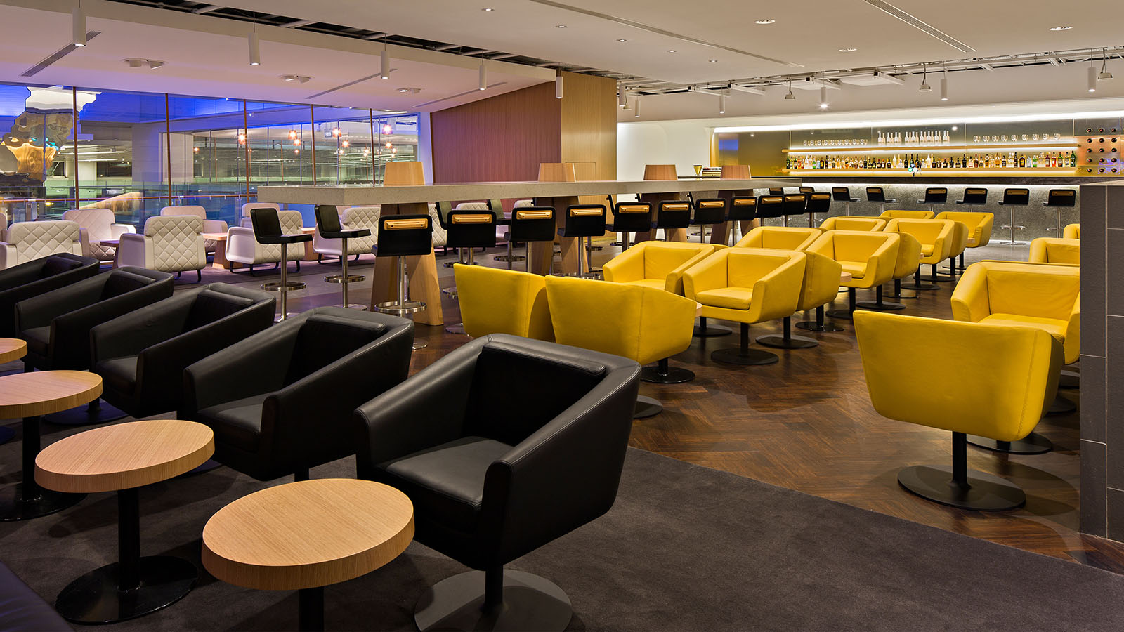 Black and yellow coloured seats at the Qantas International Business Lounge in Singapore