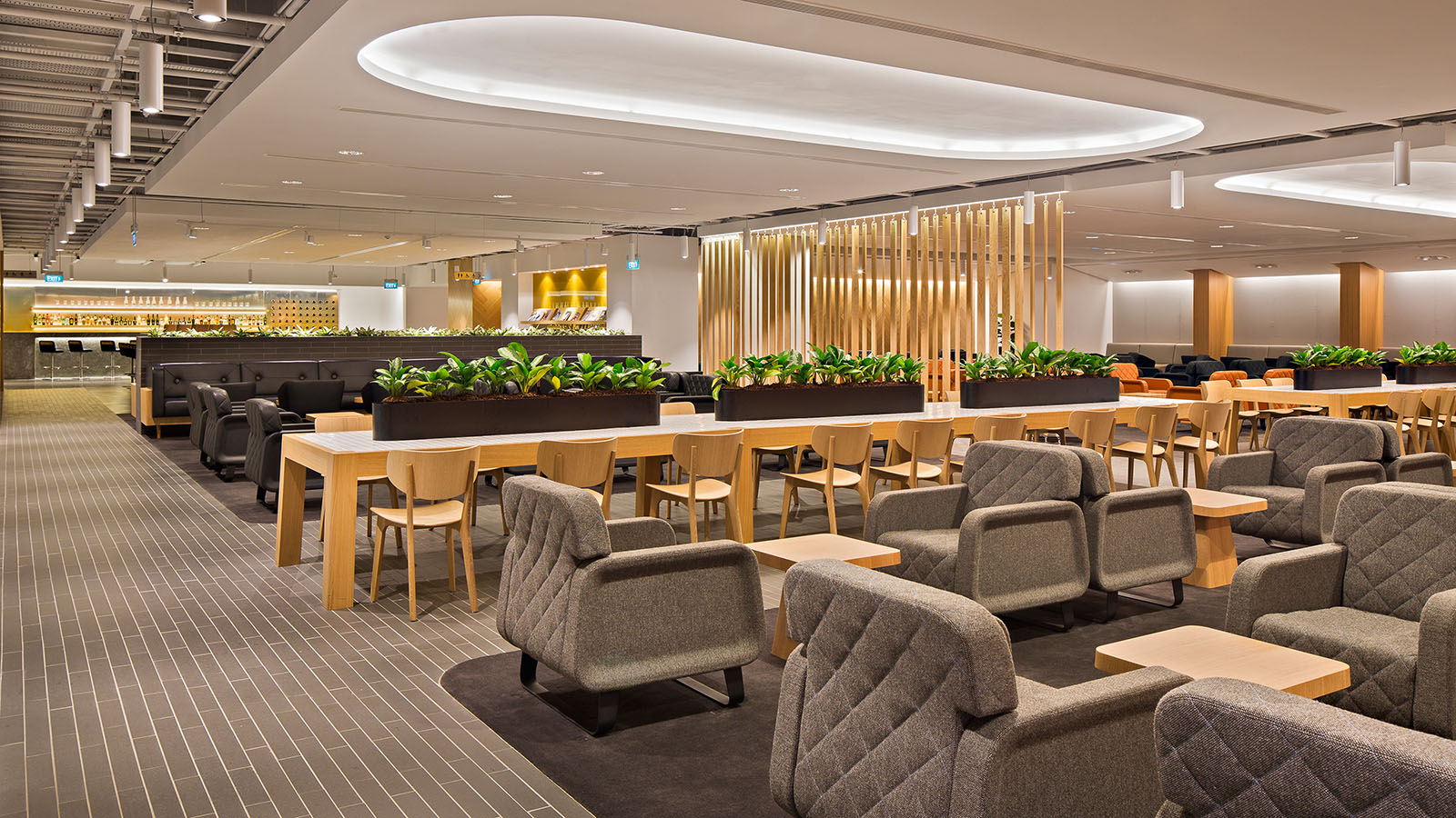 Grey, black and timber seats at the Qantas International Business Lounge in Singapore