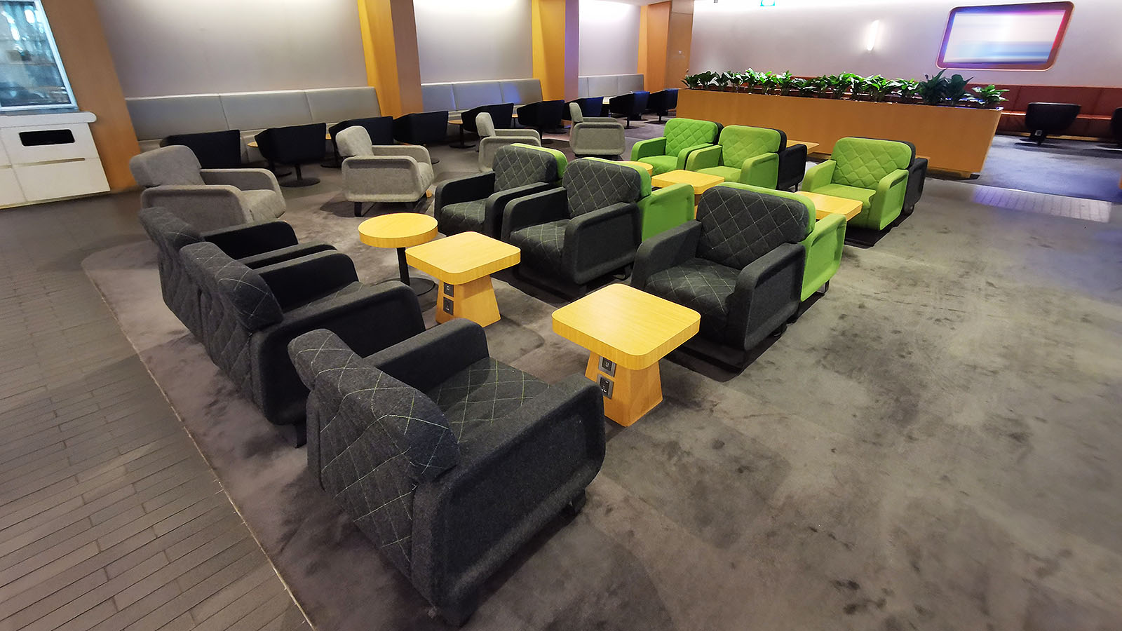 Green, black and grey coloured seats at the Qantas International Business Lounge in Singapore
