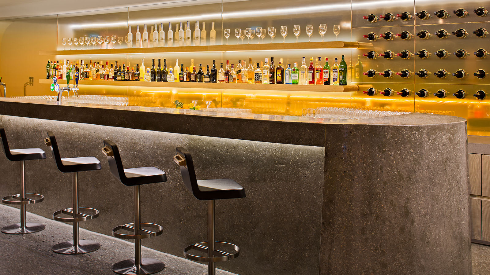 Bar counter with seating at the Qantas International Business Lounge in Singapore