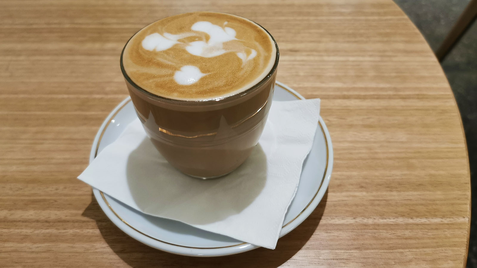 Latte in a glass at the Qantas International Business Lounge in Singapore