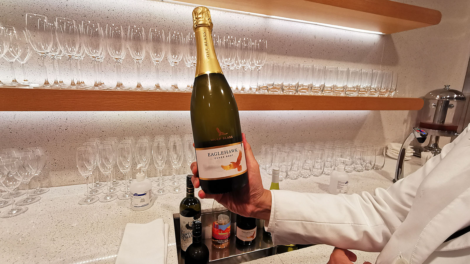 Waiter holding sparkling wine at the Qantas International Business Lounge in Singapore