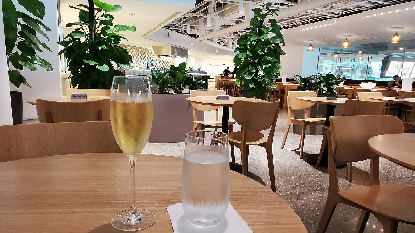 Glass of Champagne and water at the Qantas International Business Lounge in Singapore