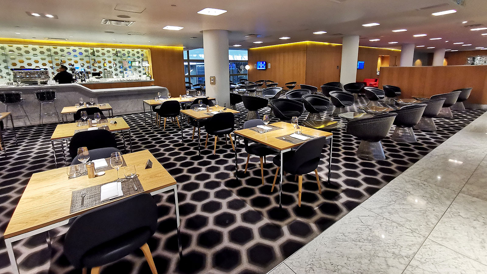 Tables and chairs in the Qantas LA First Lounge