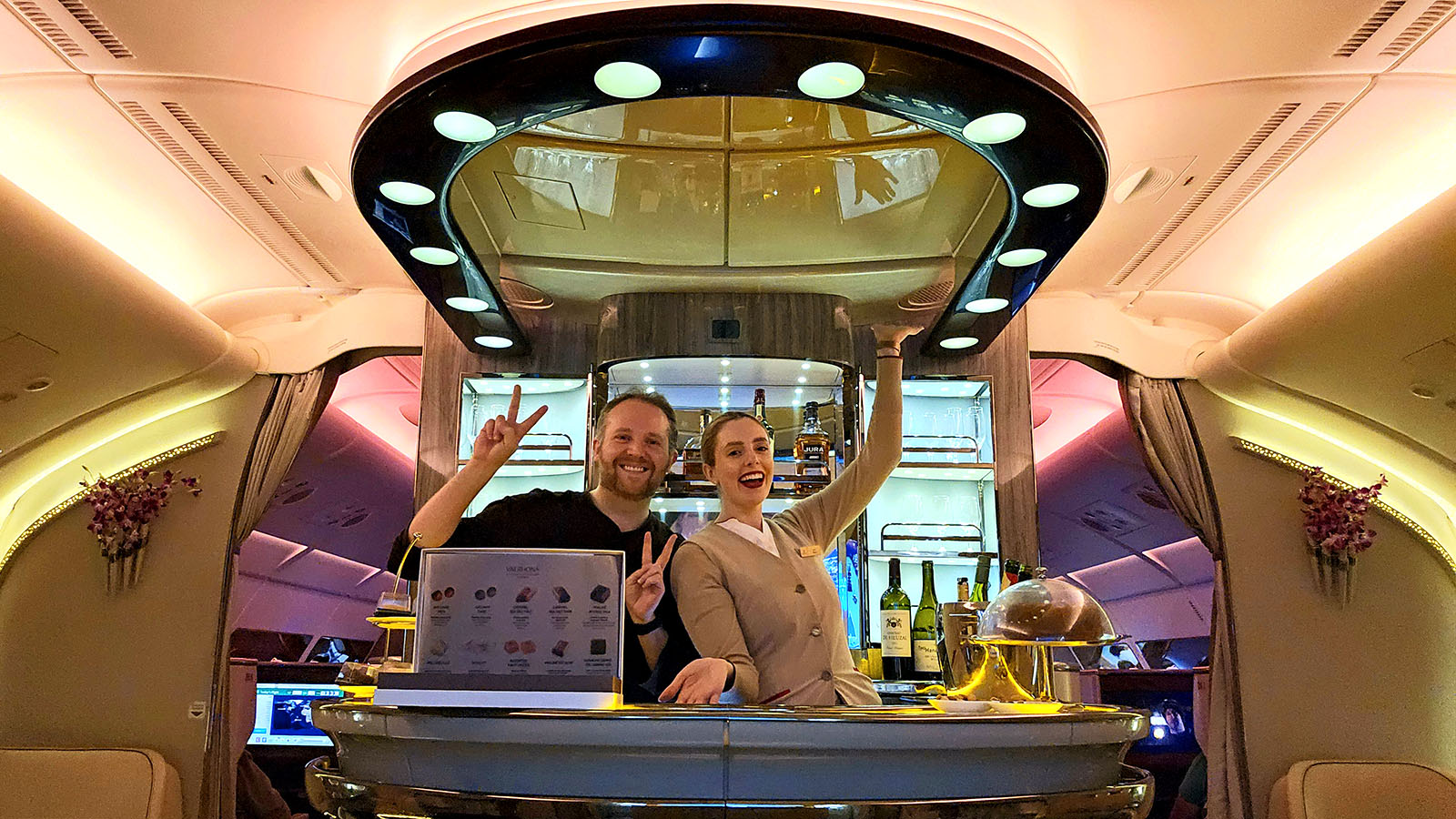 Passenger and crew in the Emirates A380 onboard lounge