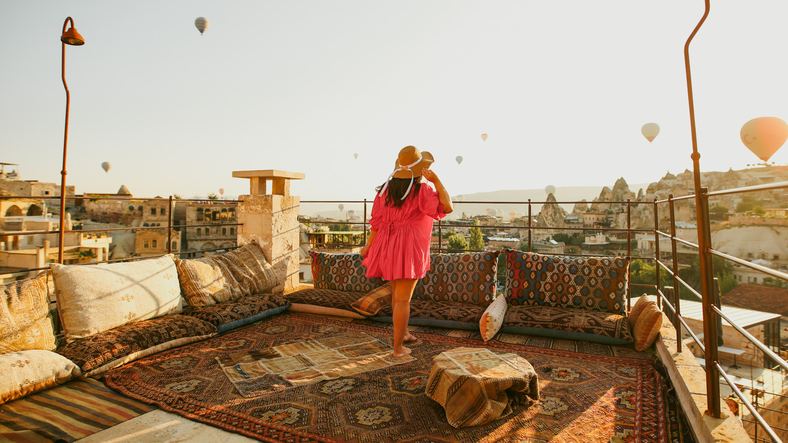 Hot air balloons at sunrise from rooftop at Caverna Hotel Premium Suites, Goreme