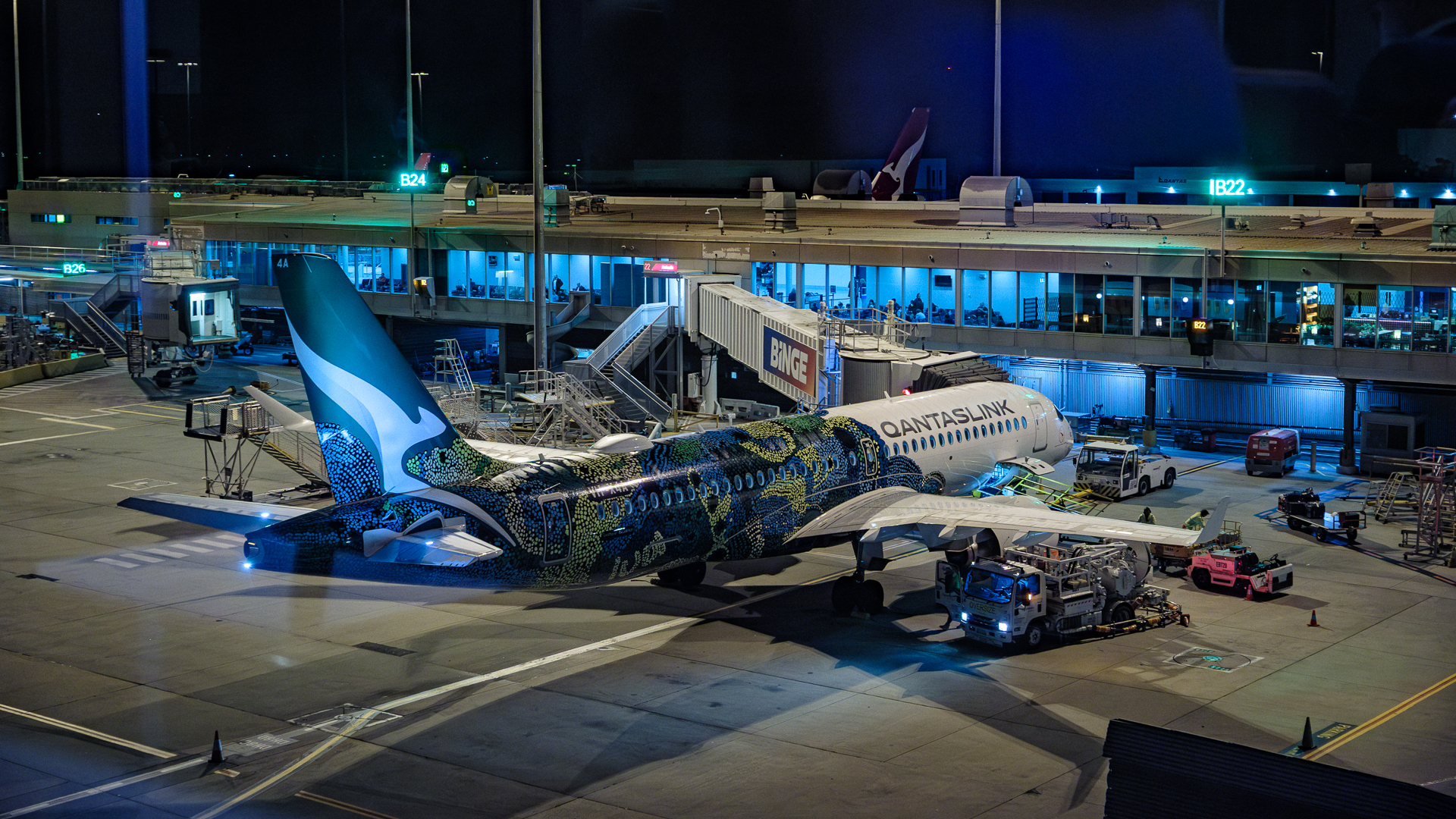 The special green Minyma Kutjara Tjukurpa lQantas Airbus A220 waiting for boarding.