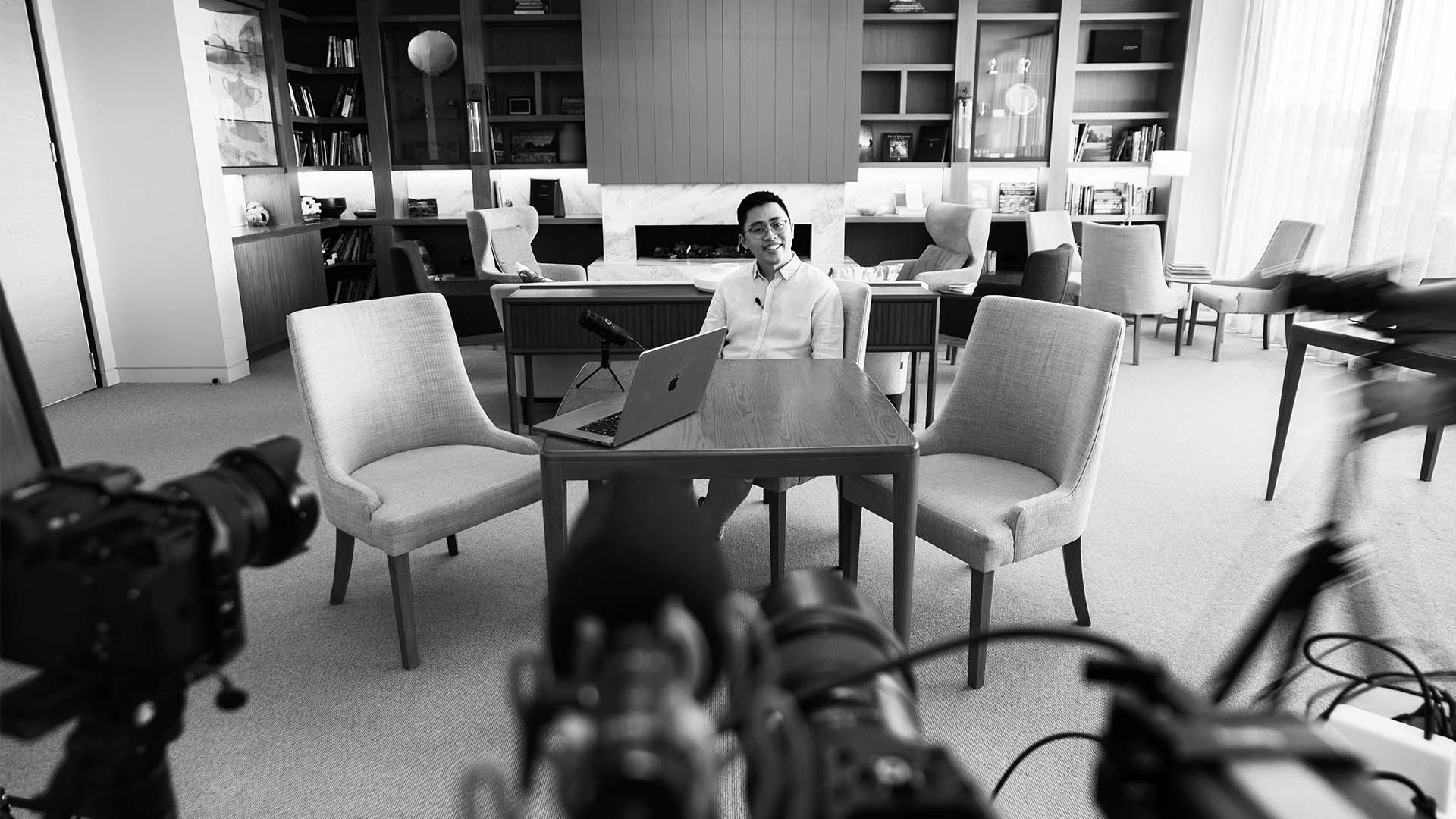 Brandon Loo surrounded by cameras.